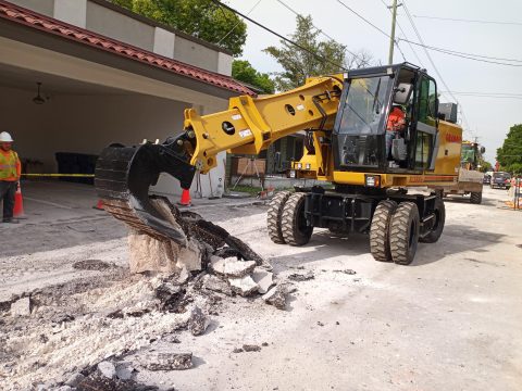 rental construction equipment tearing up a street