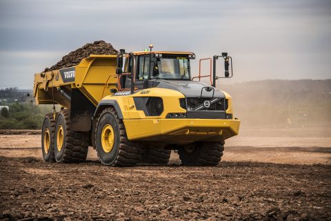 heavy equipment rental machine hauling materials at a job site