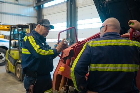 mechanics performing heavy equipment maintenance