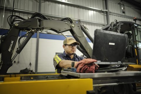 mechanic performing inspections for heavy equipment winterization