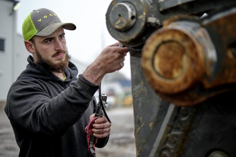 mechanic winterizing heavy equipment