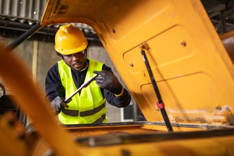 construction worker inspecting used heavy equipment