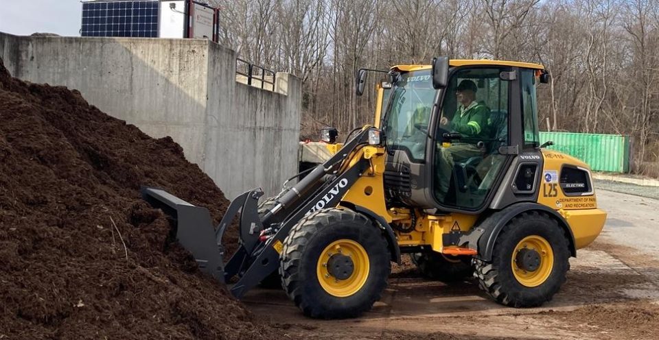 Volvo L25 electric front loader pushing into a pile of dirt.;